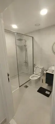 a bathroom with a shower and a toilet and a sink at Silk Valley - Luxury 1BR: Steps to Barasti Beach & Marina Walk in Dubai