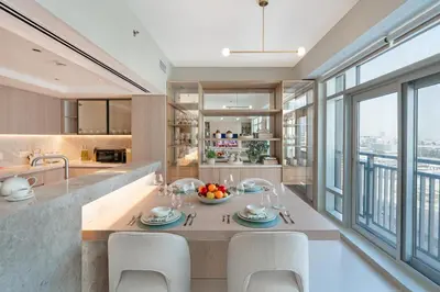 a kitchen with a dining table with chairs and a large window at Stylish 1BDR Fully Upgraded Near Burj Khalifa in Dubai