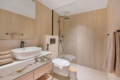 a bathroom with a sink and a glass shower at Stylish 1BDR Fully Upgraded Near Burj Khalifa in Dubai