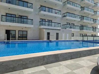 a large swimming pool in front of a building at Equity Gate 217 in Dubai