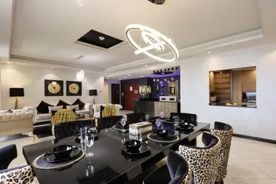 a dining room with a table and chairs at Prime JBR 4B with Maid with Sea and Ain Dubai View in Dubai