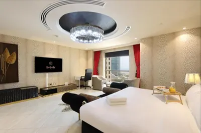 a living room with a couch and a table in a room at Prime JBR 4B with Maid with Sea and Ain Dubai View in Dubai