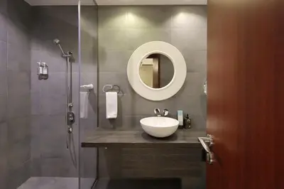 a bathroom with a sink and a shower with a mirror at Prime JBR 4B with Maid with Sea and Ain Dubai View in Dubai