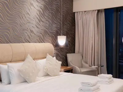 a hotel room with a bed and a chair at Hollywood Glamour Epic Burj Views at DAMAC Towers by Paramount in Dubai