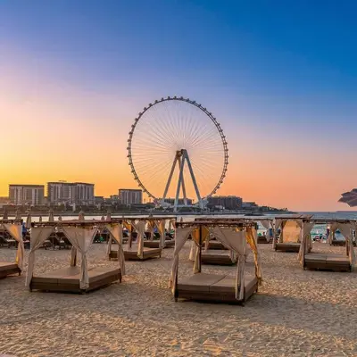 a ferris wheel on the beach at sunset at Stunning Sea View - 2-BR - 2 min Walk to Beach in Dubai
