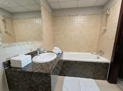 a bathroom with a sink and a bath tub at Stunning Sea View - 2-BR - 2 min Walk to Beach in Dubai