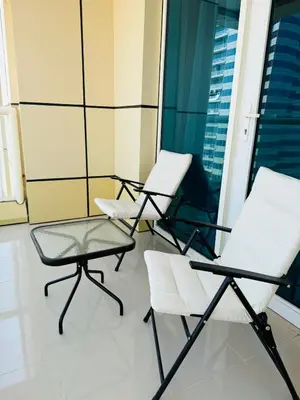 a group of chairs sitting on a balcony at Palm Sea View - Dubai Marina- 2 Bedrooms in Dubai