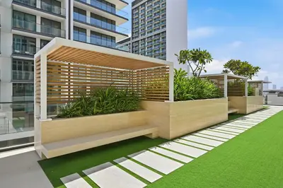 a balcony with benches and plants on a building at Binghatti House JVC - Parking, Balcony, Gym & Pool in Dubai