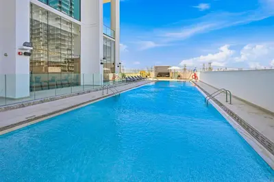 a swimming pool on the side of a building at Binghatti House JVC - Parking, Balcony, Gym & Pool in Dubai
