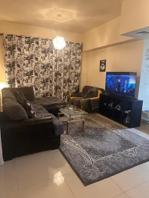 a living room with a couch and a flat screen tv at Vip private room ladies only in Dubai