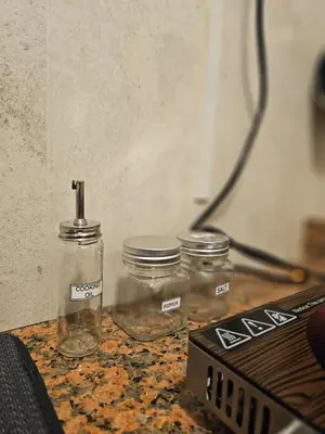 two glass jars sitting on top of a table at Elegant Grey Studio Room with Free Parking and Gaming in Dubai