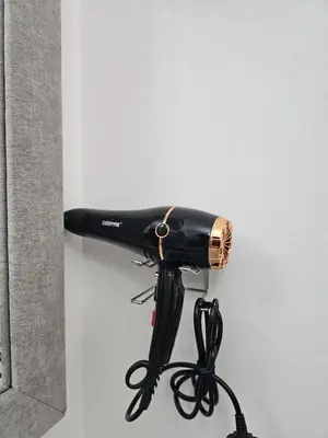 a blow dryer is attached to a wall at Elegant Grey Studio Room with Free Parking and Gaming in Dubai