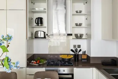a kitchen with white cabinets and a stove at Deluxe Marina Gate Suite with Sea and Ain Dubai View in Dubai