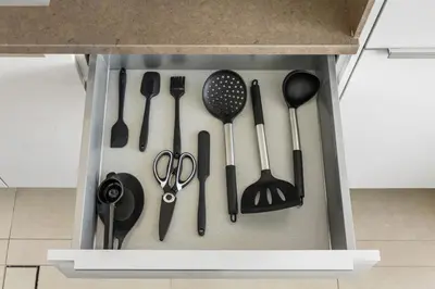 a drawer filled with cooking utensils in a kitchen at Deluxe Marina Gate Suite with Sea and Ain Dubai View in Dubai