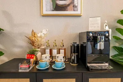 a table with a coffee maker and coffee cups on it at Boutique 3BR in JBR Upgraded by UDH in Dubai