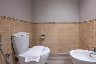 a bathroom with a toilet and a sink at Boutique 3BR in JBR Upgraded by UDH in Dubai
