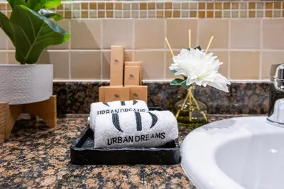 a bathroom counter with a toilet paper dispenser next to a sink at Boutique 3BR in JBR Upgraded by UDH in Dubai