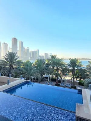 a large swimming pool with a view of the city at Fairmont North Residences Palm Jumeirah in Dubai