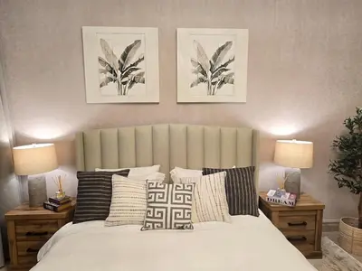 a bedroom with a large bed with pillows and two lamps at Fairmont North Residences Palm Jumeirah in Dubai