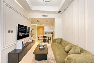 a living room with a couch and a table at DAMAC Maison Aykon City Dubai in Dubai