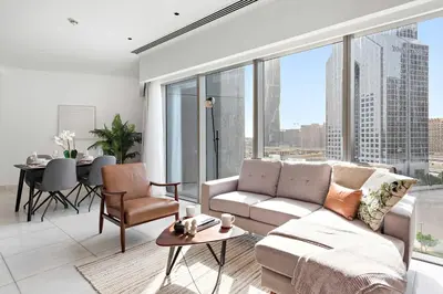 a living room with a couch and a table at Silkhaus Modern Studio in Central Park Tower DIFC in Dubai