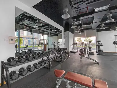 a gym with several rows of machines and chairs at Silkhaus Modern Studio in Central Park Tower DIFC in Dubai