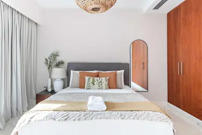 a bedroom with a large bed and a mirror at Silkhaus Modern Studio in Central Park Tower DIFC in Dubai