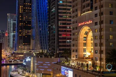 a view of a city at night with tall buildings at Cozy 2BR l Marina l Steps to Beach l Balcony l Pool in Dubai