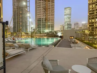 a swimming pool in a city with tall buildings at FIRST CLASS Studio Relaxing Canal View in Dubai
