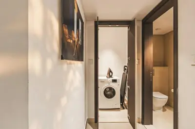 a bathroom with a washing machine and a washer and dryer at Luxury 2 Bedroom Apartment In Downtown in Dubai