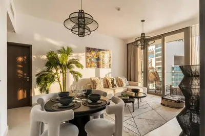 a living room with a couch and a table and chairs at Luxury 2 Bedroom Apartment In Downtown in Dubai
