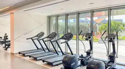 a gym with treadmills and elliptical machines at Luxury 2 Bedroom Apartment In Downtown in Dubai