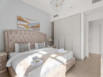 a bedroom with a large bed with towels on it at The Royal Suite 1 BDR in Sunset-02 in Dubai