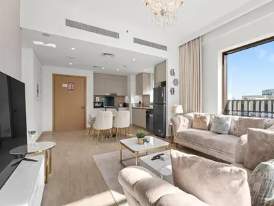 a living room with a couch and a table at The Royal Suite 1 BDR in Sunset-02 in Dubai