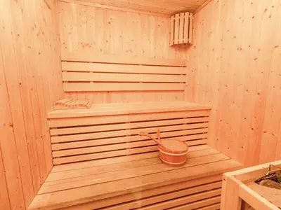 a wooden sauna with a bucket in it at Modern Comfort City Studio In Al Manara 04 in Dubai