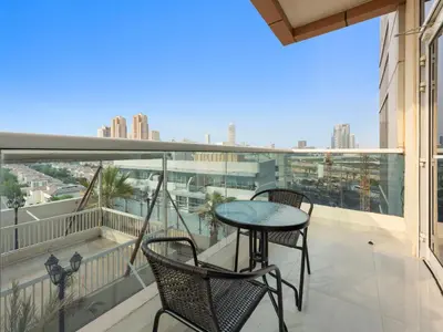 a balcony with two chairs and a table on a balcony at Modern Comfort City Studio In Al Manara 04 in Dubai