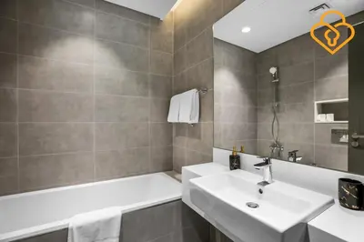 a bathroom with a sink and a bath tub at Beautiful Large 1BR Apt in District 1, MBR Minutes to Downtown in Dubai