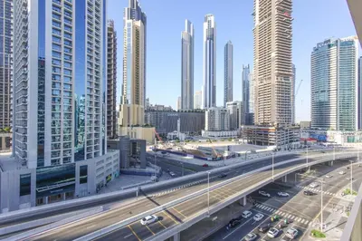 a highway in a city with many tall buildings at Chic Getaway with Downtown View, Walk to Dubai Mall and Burj in Dubai