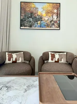 a living room with two chairs and a coffee table at 4 Months Offer Brand new Modern Prime Amenities in Dubai