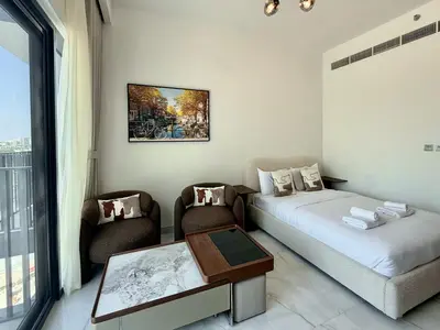 a room with a bed and a table and chairs at 4 Months Offer Brand new Modern Prime Amenities in Dubai