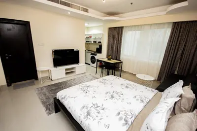 a living room with a bed and a flat screen tv at Fully Furnished Studio at City Tower al Barsha Near Mall of the Emirates in Dubai