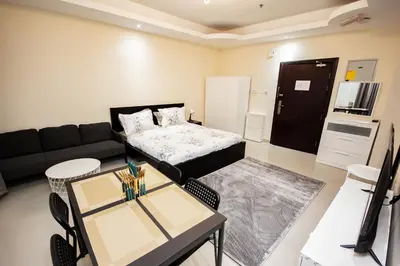 a living room with a couch and a table at Fully Furnished Studio at City Tower al Barsha Near Mall of the Emirates in Dubai