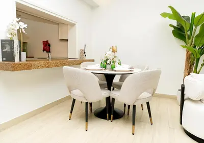 a dining room with a table and chairs at Luxury Executive 1BR with Full Burj Khalifa View- Downtown in Dubai