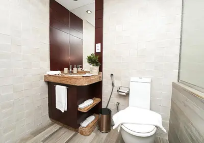 a bathroom with a toilet and a sink at Luxury Executive 1BR with Full Burj Khalifa View- Downtown in Dubai