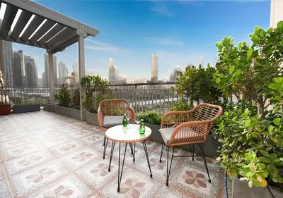 a patio with two chairs and a table on a balcony at Luxury Executive 1BR with Full Burj Khalifa View- Downtown in Dubai