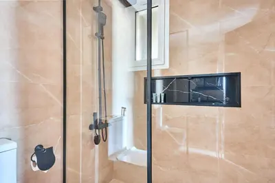 a shower with a glass door in a bathroom at Frank Porter - Al Rabia Tower in Dubai