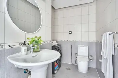 a white bathroom with a sink and a mirror at Frank Porter - Al Rabia Tower in Dubai