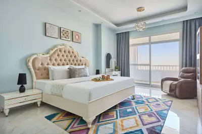a bedroom with a large white bed and a large window at Frank Porter - Al Rabia Tower in Dubai