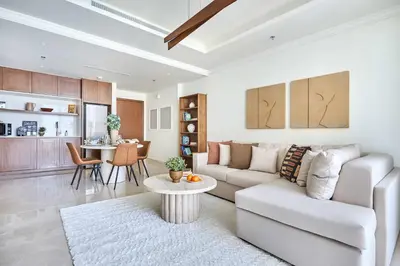 a living room with a couch and a table at Frank Porter - Palace Beach Residence in Dubai