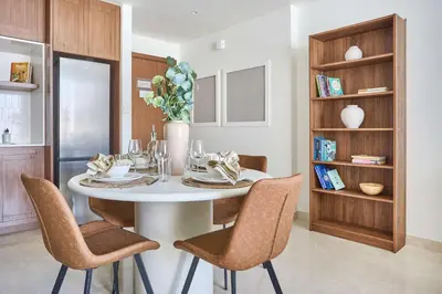 a dining room with a white table and chairs at Frank Porter - Palace Beach Residence in Dubai